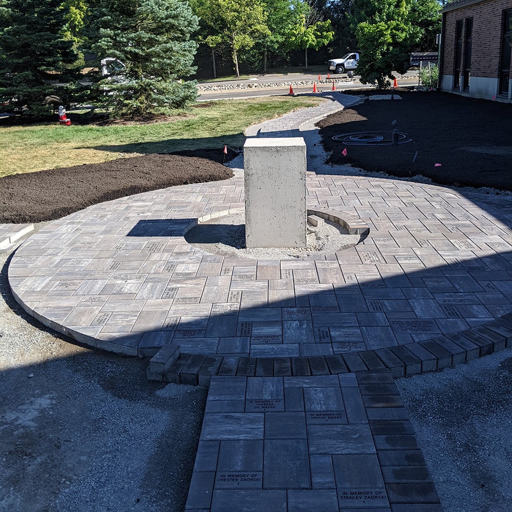Image of the installation process of the patio courtyard and walkway at St. John's Church.