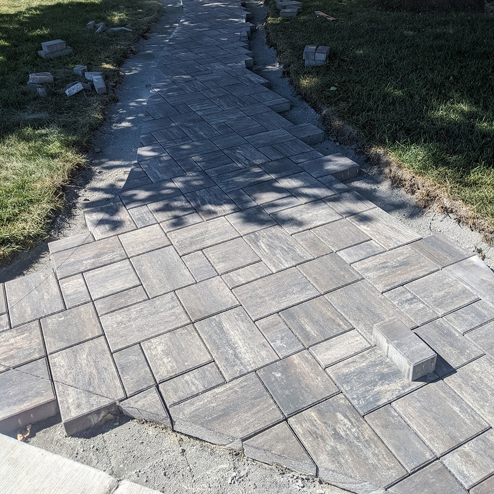 Close-up image of bricks being laid for a walkway.