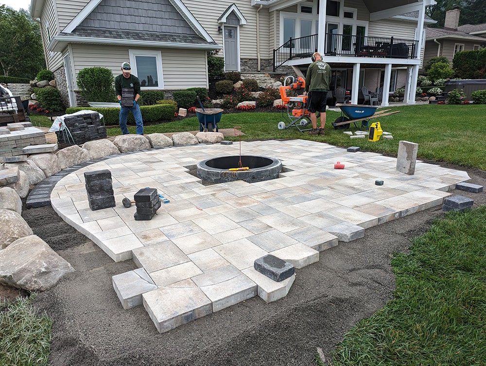 Image of the Bladerunners crew laying the bricks for the patio.