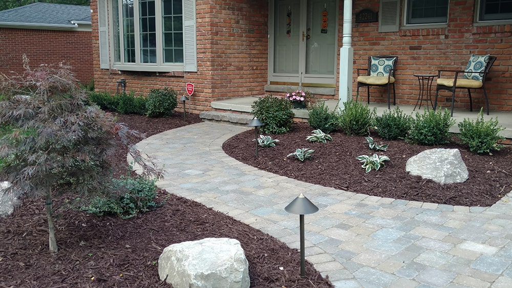 Image of a new brick walkway to a residential home, installed by BladeRunners Landscaping.