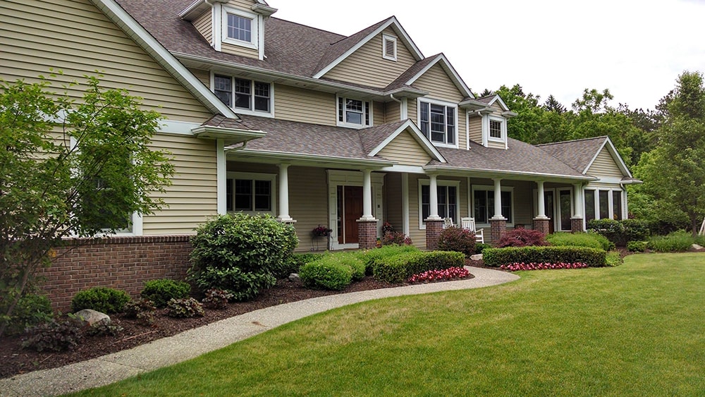 Image of the front of a home with new landscaping, completed by BladeRunners Landscaping.
