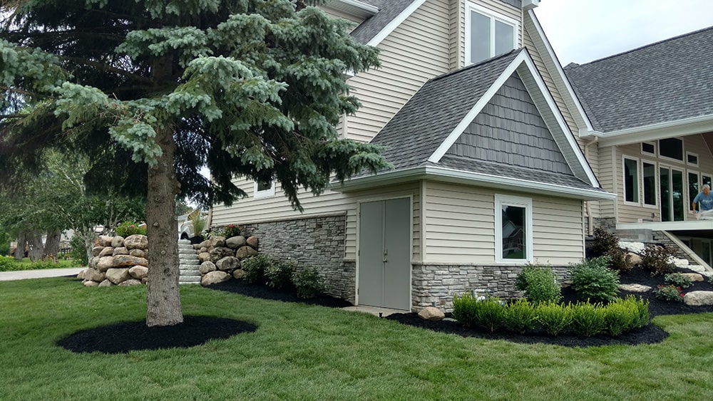 After: Image of the same home with fresh landscaping provided by BladeRunners Landscaping.
