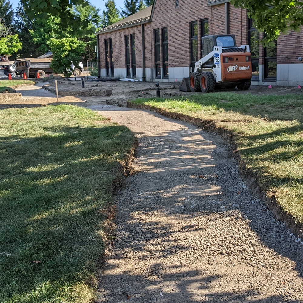 Image of BladeRunners’ crew digging a path for a new brick walkway.